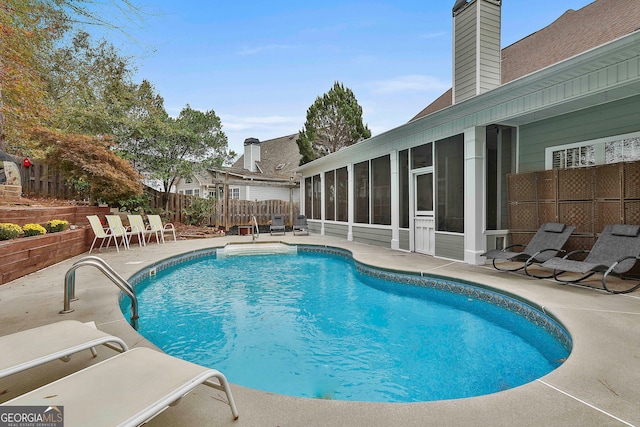 view of pool with a patio area and a sunroom