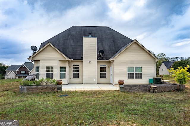 back of property featuring a patio and a yard