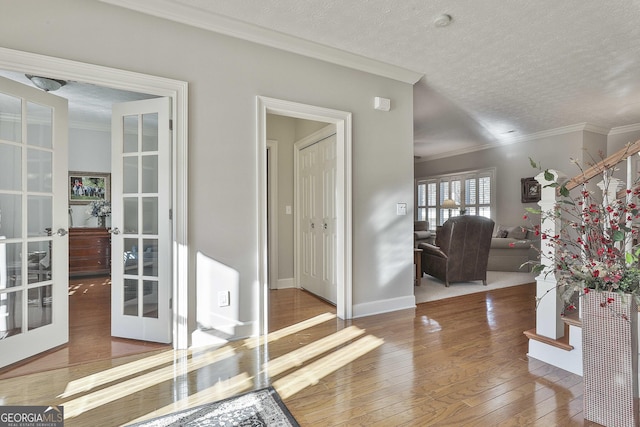 interior space with crown molding, french doors, and wood-type flooring