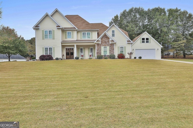 craftsman house featuring a garage, a front yard, and stone siding