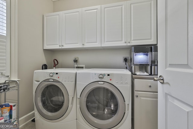 laundry area with washer and dryer, baseboards, and cabinet space