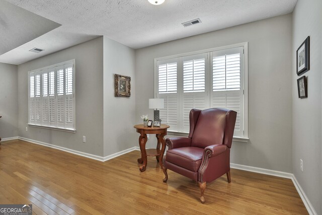 bedroom featuring a textured ceiling and light wood-type flooring