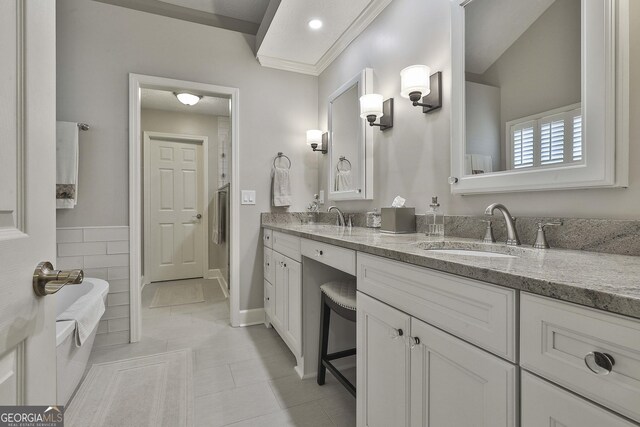 bathroom with a textured ceiling, tile walls, a tub to relax in, and tile patterned floors