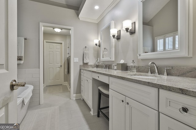 full bathroom with tile patterned flooring, double vanity, a bathtub, and a sink