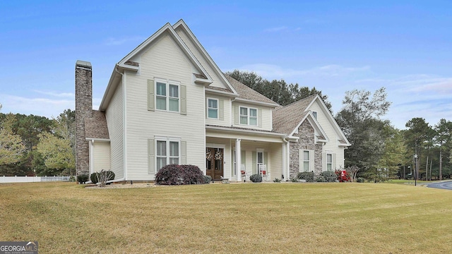 view of front of house with a chimney and a front lawn