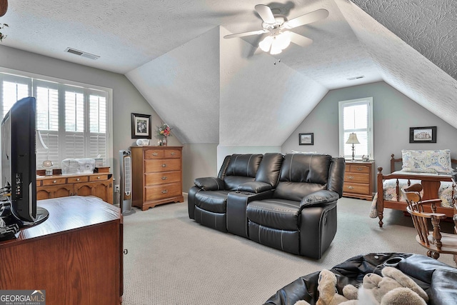 living room with light colored carpet, lofted ceiling, and plenty of natural light