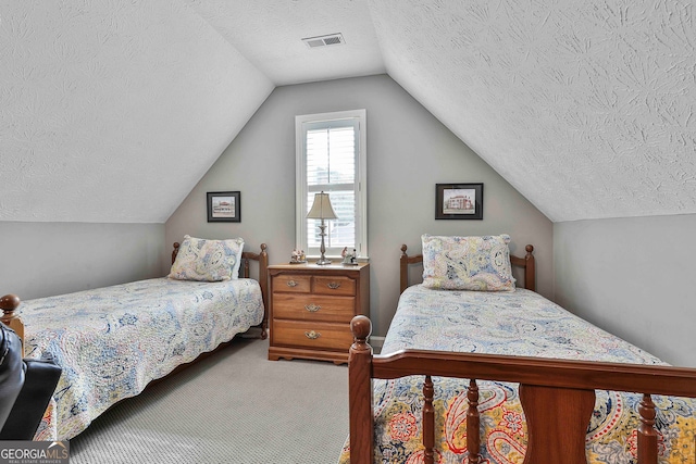 carpeted bedroom featuring a textured ceiling and lofted ceiling