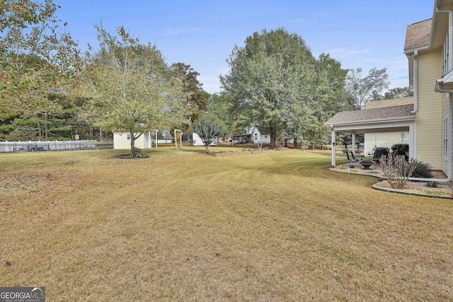 view of yard featuring fence and a patio area