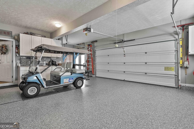 garage with a garage door opener and baseboards