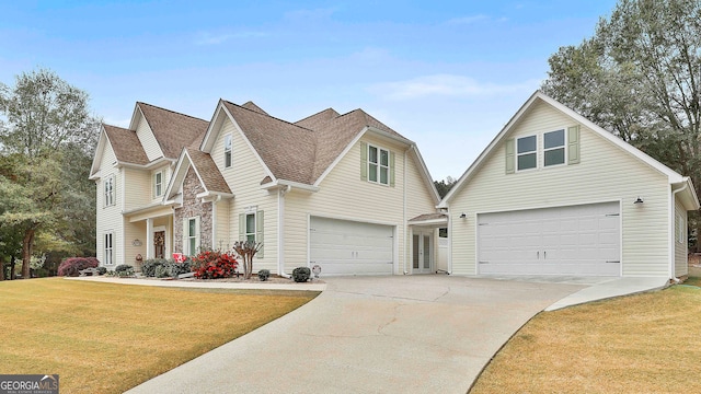 view of front property featuring a garage and a front yard