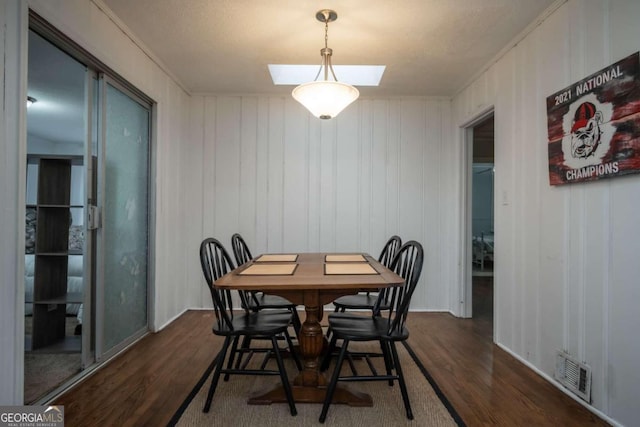 dining room with dark hardwood / wood-style floors