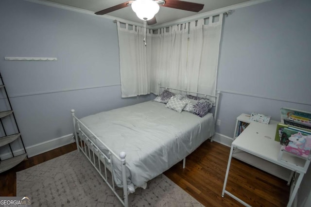 bedroom with ceiling fan, dark hardwood / wood-style floors, and ornamental molding