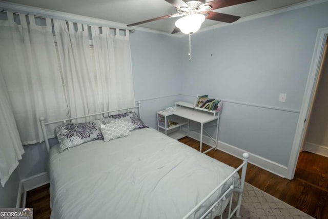 bedroom with ornamental molding, ceiling fan, and dark hardwood / wood-style floors