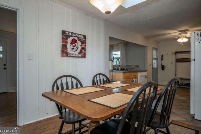 dining area with dark hardwood / wood-style flooring, ceiling fan, and sink