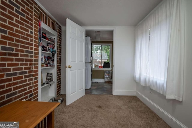 corridor featuring crown molding and carpet floors