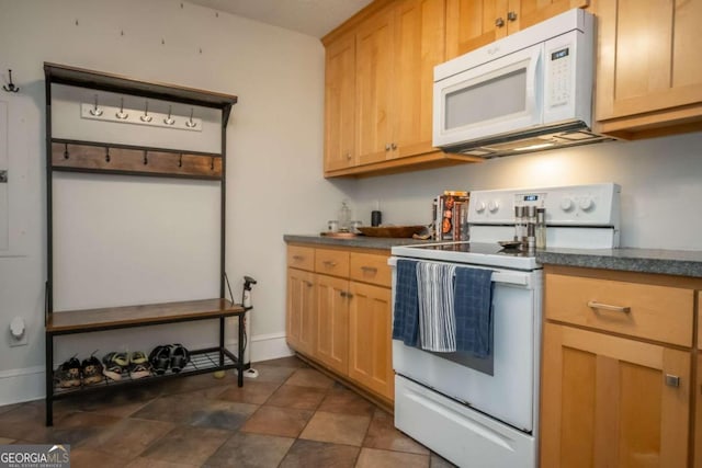 kitchen with light brown cabinets and white appliances