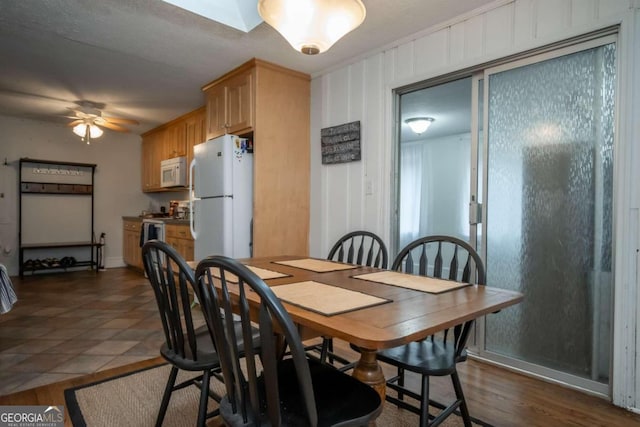 tiled dining room with ceiling fan