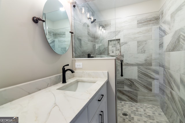 bathroom with vanity and a shower with shower door