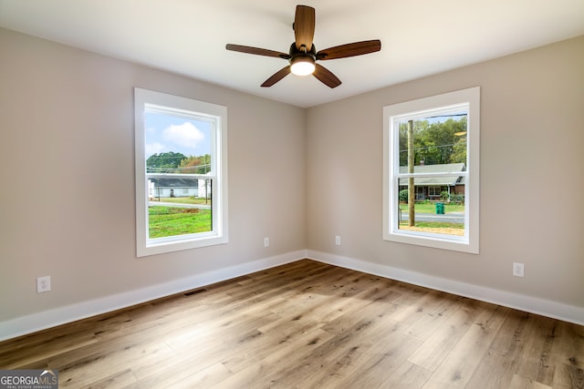 unfurnished room featuring light hardwood / wood-style floors and ceiling fan