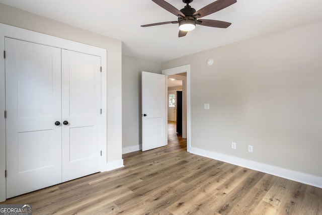 unfurnished bedroom with a closet, ceiling fan, and light hardwood / wood-style flooring