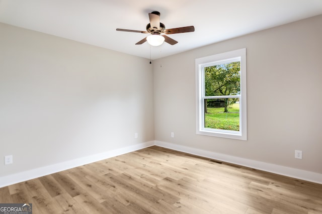 empty room featuring ceiling fan and light hardwood / wood-style flooring