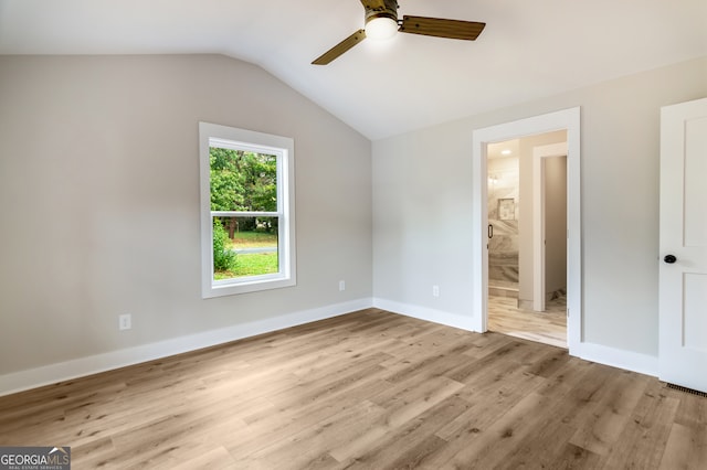 unfurnished bedroom with ensuite bathroom, light hardwood / wood-style floors, lofted ceiling, and ceiling fan