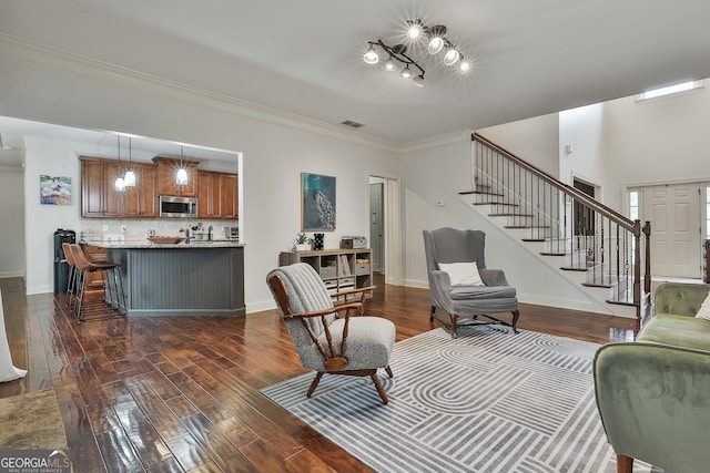 living room featuring dark hardwood / wood-style flooring and ornamental molding