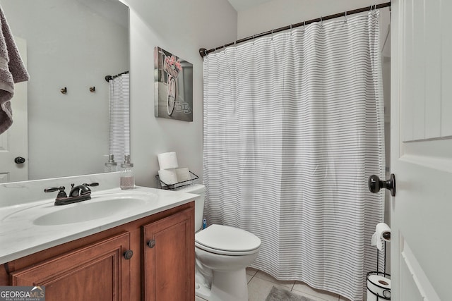 bathroom featuring tile patterned flooring, vanity, and toilet