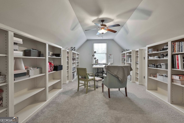 office space featuring light carpet, ceiling fan, and vaulted ceiling