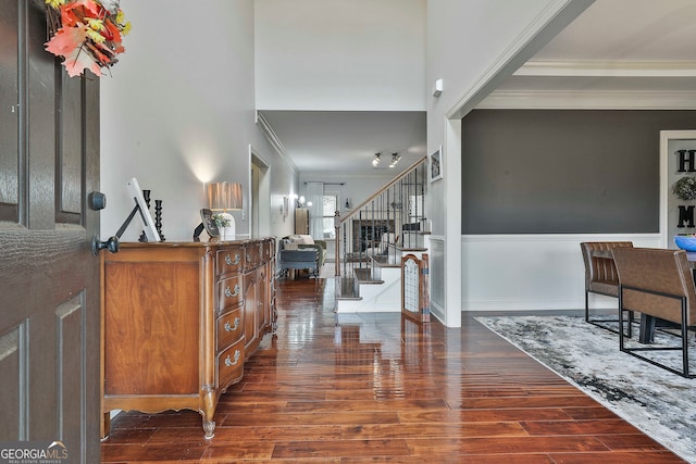 foyer with dark hardwood / wood-style floors and crown molding