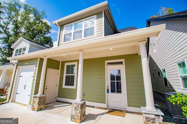 view of front of property featuring a porch and a garage