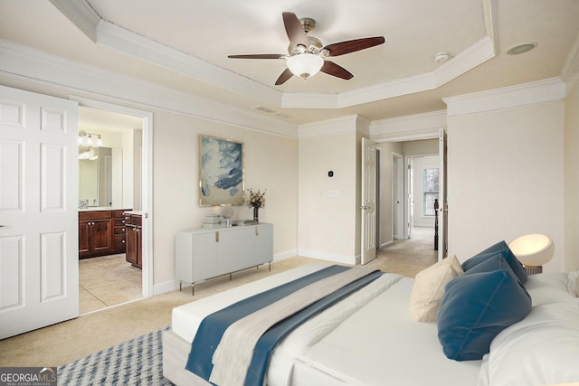 carpeted bedroom with ceiling fan, crown molding, connected bathroom, and a tray ceiling