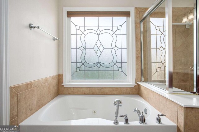 bathroom with tile patterned floors, vanity, and shower with separate bathtub