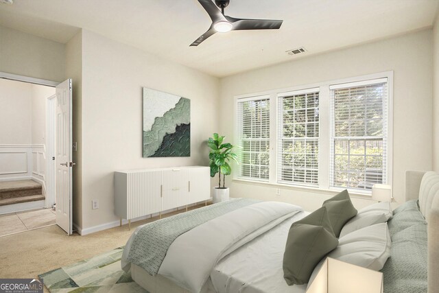 carpeted bedroom featuring a closet and ceiling fan