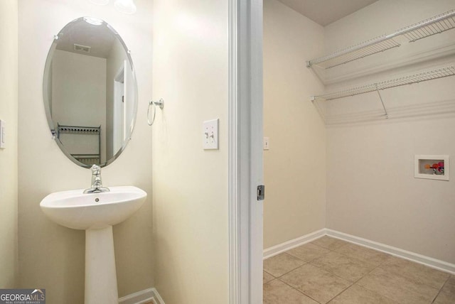 laundry area with washer hookup, electric dryer hookup, and light tile patterned flooring