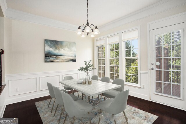 dining room featuring a chandelier, crown molding, and dark wood-type flooring