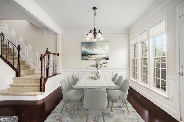 dining area with dark wood-type flooring, crown molding, a healthy amount of sunlight, and a notable chandelier