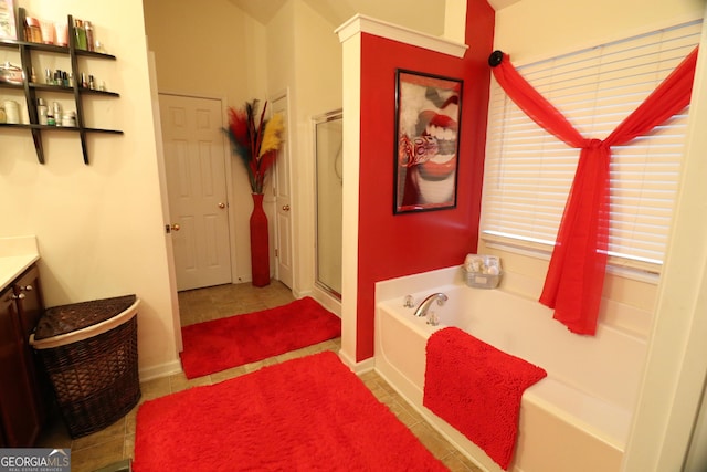 bathroom with tile patterned flooring, vanity, and independent shower and bath