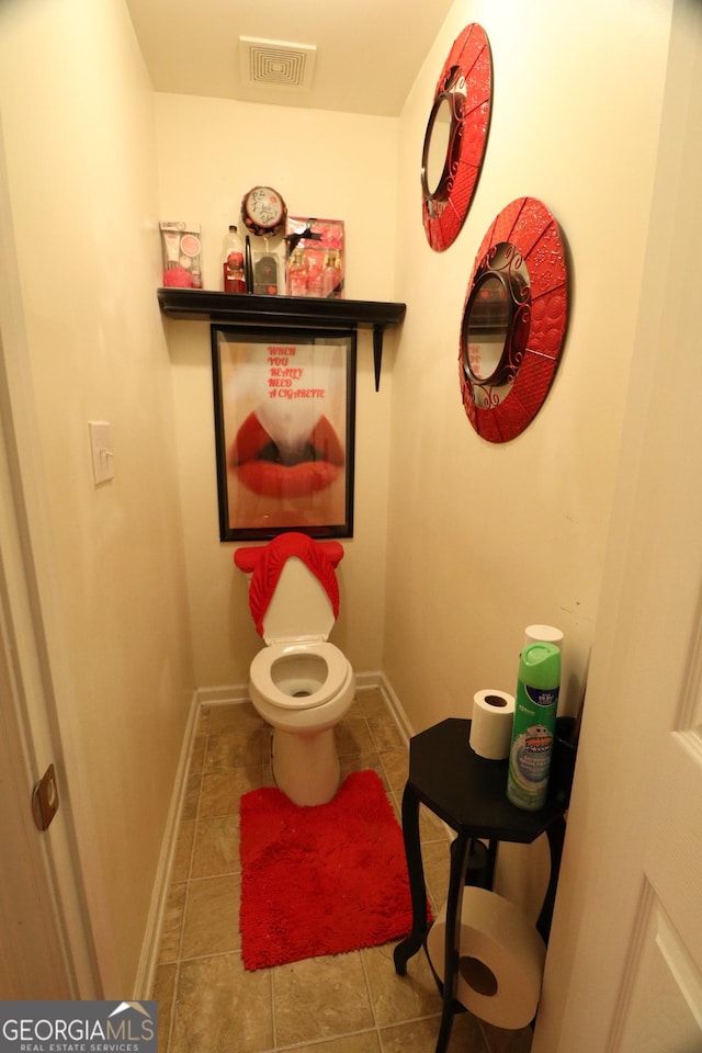 bathroom featuring tile patterned flooring and toilet