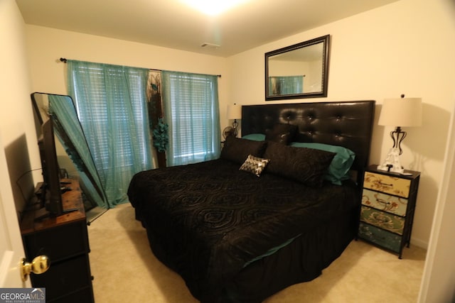 bedroom featuring light carpet