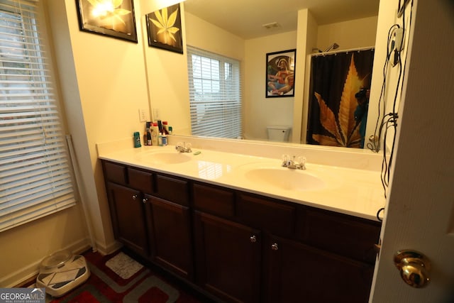 bathroom featuring vanity and toilet