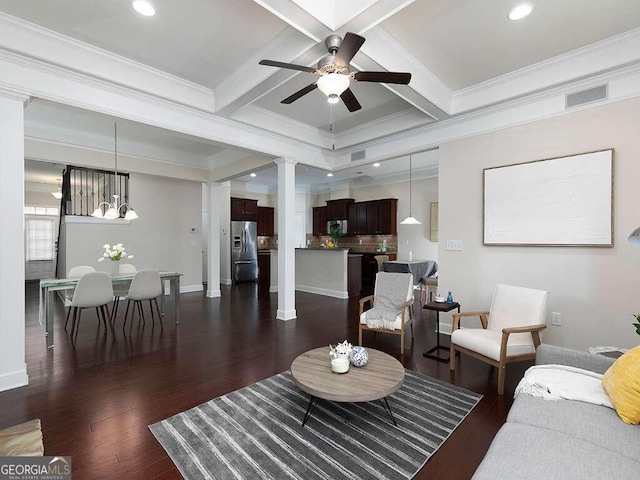 living room featuring ornamental molding, ceiling fan with notable chandelier, beamed ceiling, and dark hardwood / wood-style floors