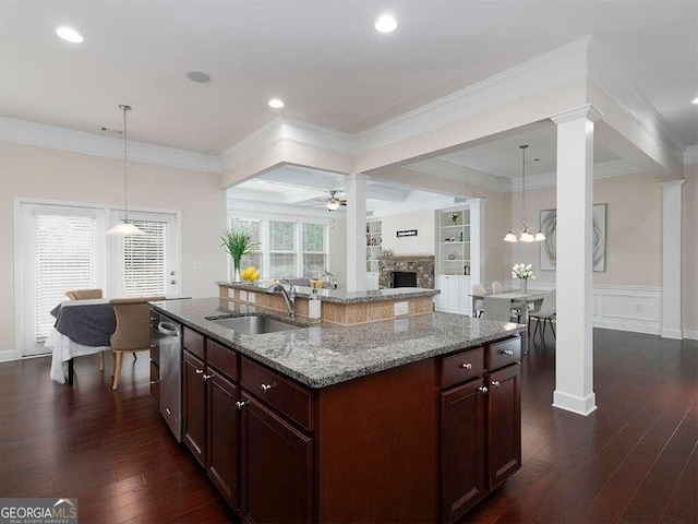 kitchen featuring a center island with sink, sink, and ornamental molding