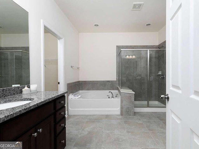 bathroom with vanity and plus walk in shower