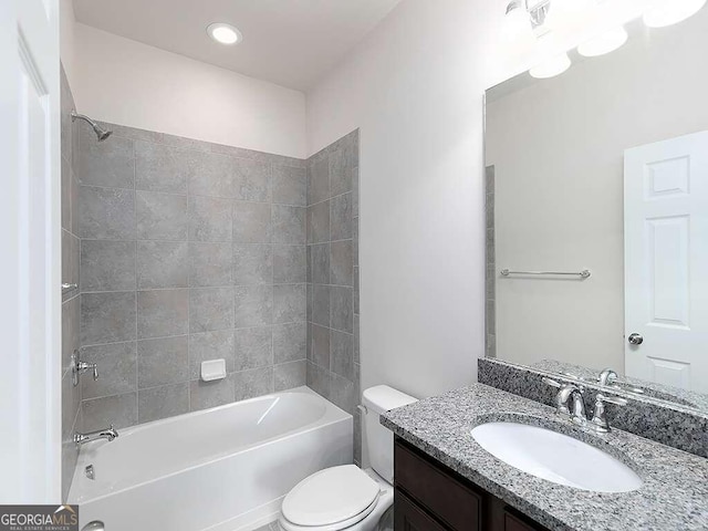 full bathroom featuring vanity, toilet, and tiled shower / bath combo