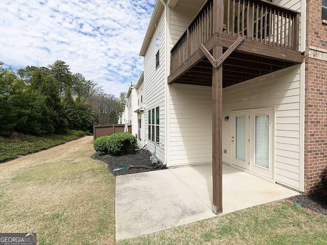 view of side of home with a yard and a patio area