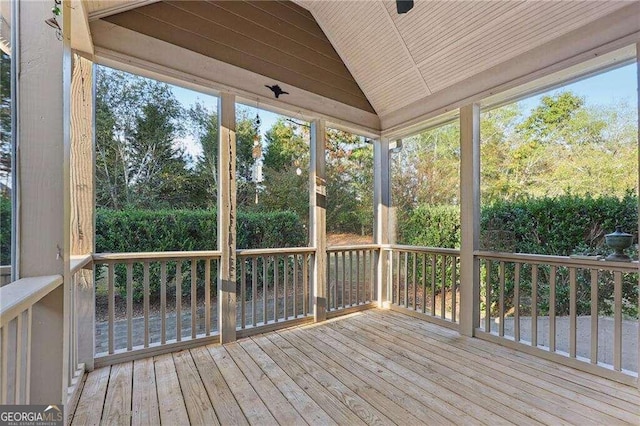 unfurnished sunroom featuring a wealth of natural light, wood ceiling, and vaulted ceiling