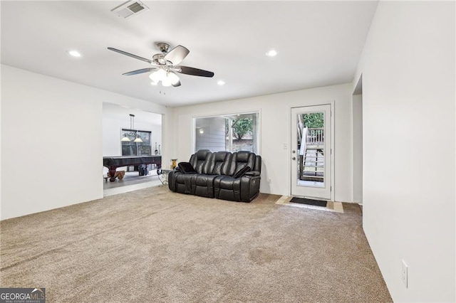 carpeted living room featuring ceiling fan