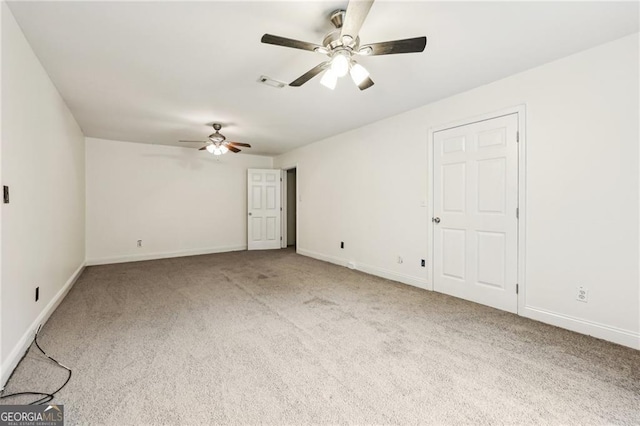 spare room featuring ceiling fan and carpet