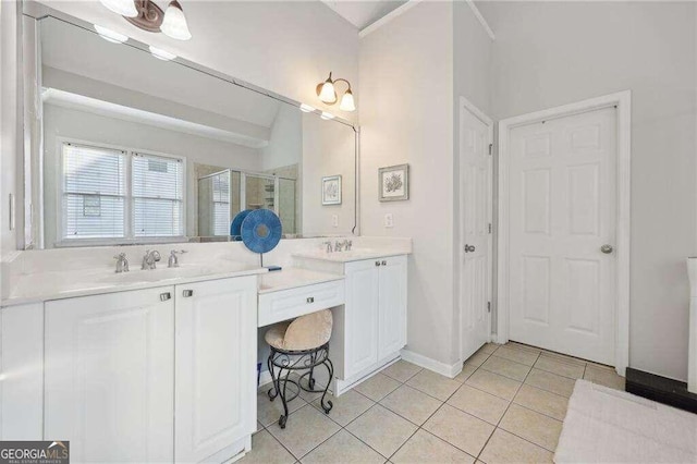 bathroom featuring tile patterned floors, vanity, a shower with shower door, and vaulted ceiling